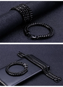 Close-up of black stainless steel Cuban link chain necklace and matching bracelet set