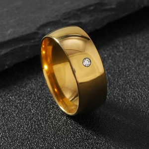Gold plated 8mm wide stainless steel ring with a single round diamond on black stone