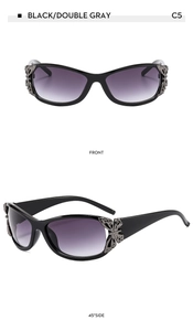 Detail of butterfly metal temple on black sunglasses with grey gradient lenses