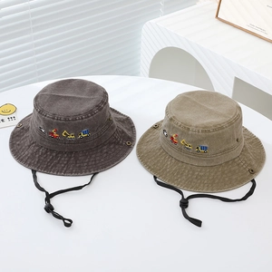 Close-up of kids bucket hat featuring construction vehicle embroidery and adjustable chin strap