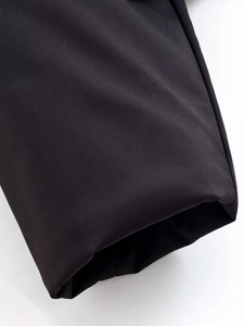 Close-up of high-quality black twill fabric detailing the texture and stitching on the cuff