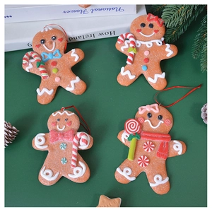 Close-up of four gingerbread man ornaments with detailed icing textures on a pine background