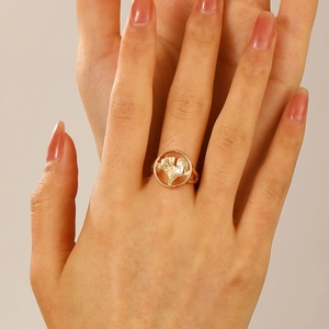 Minimalist golden ginkgo leaf ring on model hand with detailed hollow design finish