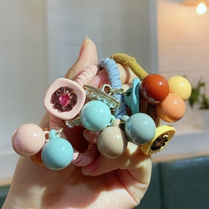 Close-up of candy-colored elastic hair ties with acrylic beads and pearl details