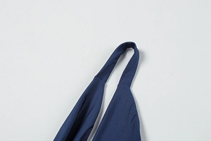 Macro detail of dark blue knitted fabric texture and halter neck strap stitching