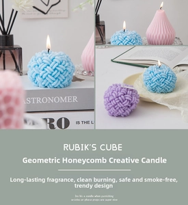Detailed view of macaron colored geometric scented candles with honeycomb and yarn ball shapes