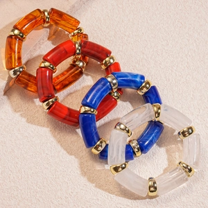 Chunky acrylic geometric bamboo-style stretch bracelets in amber, red, blue, and marbled white