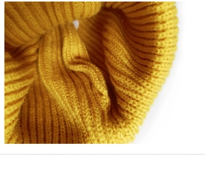 Macro shot of ginger yellow ribbed knit fabric texture showing detail of kids beanie