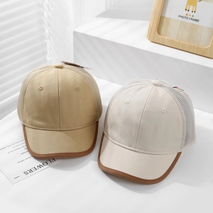 Close-up of mesh baseball caps in khaki and cream white with breathable mesh detail