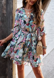 Detailed view of floral chiffon dress featuring V-neckline and tiered ruffle hemline