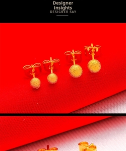 Macro view of matte frosted gold ball earrings with butterfly clasp on red fabric