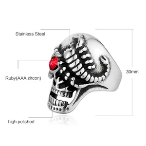 Polished stainless steel skull ring with scorpion detail and red cubic zirconia eye