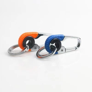 Detail of dual-tone metal car keychains with orange and blue silicone rings