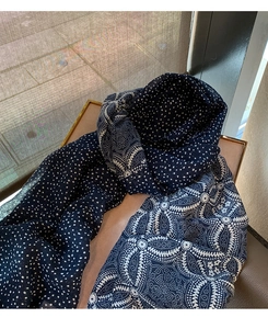 Detail of navy blue cotton linen scarf with white polka dots and wavy geometric patterns