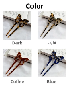Detail view of butterfly shaped acetate hair pins in four vintage tortoiseshell colors