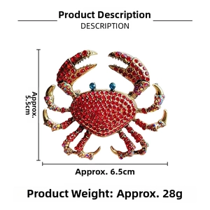Detailed size view of a gold crab brooch with red rhinestones and blue crystal eyes