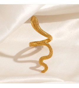Detail of gold snake ring with realistic scales on elegant silk background