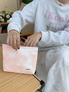 Pink and white tie-dye canvas toiletry bag with zipper and logo tag for women