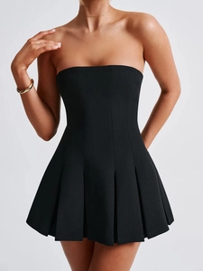 Detail view of a black strapless mini dress featuring structured lines and pleated skirt