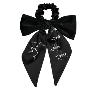 Long silk bow scrunchie with white skull print and streamers for ponytail