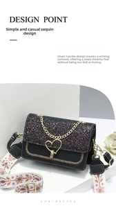 Detail of black sequin crossbody bag featuring a gold heart lock and floral strap