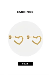 Close-up of minimalist 18k gold heart-shaped stud earrings with gold bead contouring