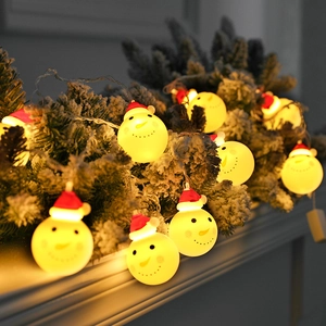 LED Christmas snowman string lights with warm yellow glow on snow-covered pine branches
