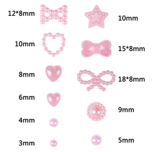 Pink pearlescent nail art charms in heart, bow, and star shapes with size markings