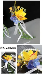 Detail of yellow cymbidium orchid cup flower decor with ribbons and pearl beads