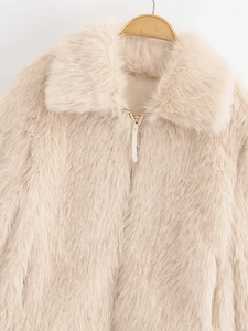 Detailed view of beige faux fur jacket showing wide lapels and metal zipper closure