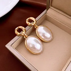 French vintage round pearl earrings with chunky gold metal rings in a jewelry box