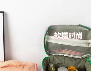 Internal view of purple toiletry bag featuring mesh dividers and green lining detail