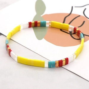 Colorful Tila bead bracelet with bohemian style enamel tiles on white background