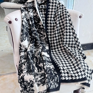Close-up of double-sided cashmere scarf showing houndstooth pattern and ink painting texture