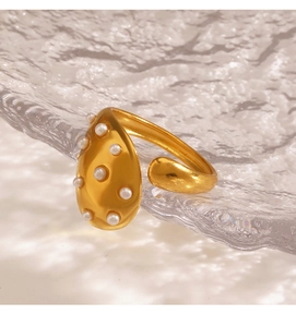 Detail of gold-plated stainless steel ring with elegant pearls and open adjustable band
