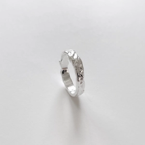 Macro shot of 925 sterling silver ring with irregular hammered lava texture detail