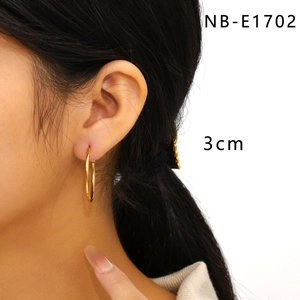 Close-up of 3cm gold-plated stainless steel hoop earring worn on female ear model