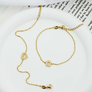 Gold stainless steel heart and pentagon bracelet set with cubic zirconia inlays