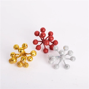 Close-up of sparkling gold red and silver Christmas glitter berry sprigs for DIY wreaths