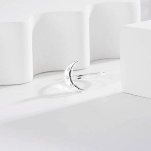 Elegant S925 sterling silver crescent moon ring with sparkling inlaid crystals on white background