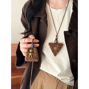 Detail of leopard print plush trapezoid pendants with bronze bear and heart charms