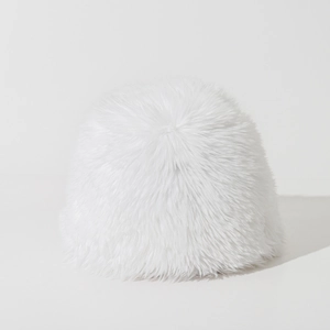 Macro shot of fluffy white faux fur texture and long fibers on the warm winter bucket hat