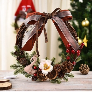Handcrafted festive Christmas wreath with swan decoration and pine cones on a wooden table