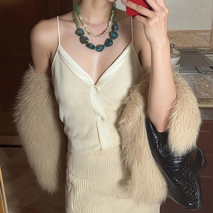 Vintage layered acrylic necklace with green stone beads on minimalist knit outfit