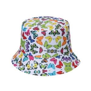 Detailed close-up showing vibrant butterfly print and stitching on a white canvas bucket hat