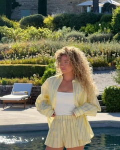 Relaxed fit striped shirt and high-waist shorts set for women in luxury resort setting