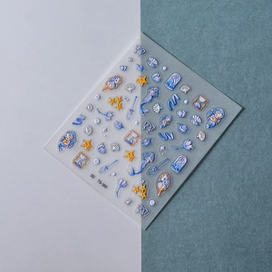 Detail of 5D embossed nail stickers featuring blue mermaid, shells, and starfish patterns