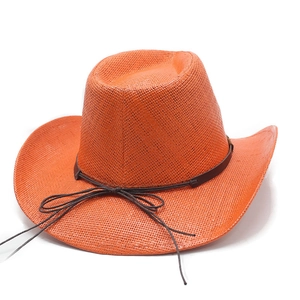 Detail of orange woven straw cowboy hat with textured surface and brown leather cord