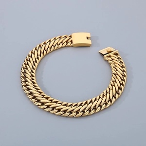 Detail of a 23mm golden braided stainless steel Cuban link bracelet with an open box clasp