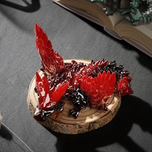 Macro shot of 3D crystal dragon sculpture on wood base with vintage book scene
